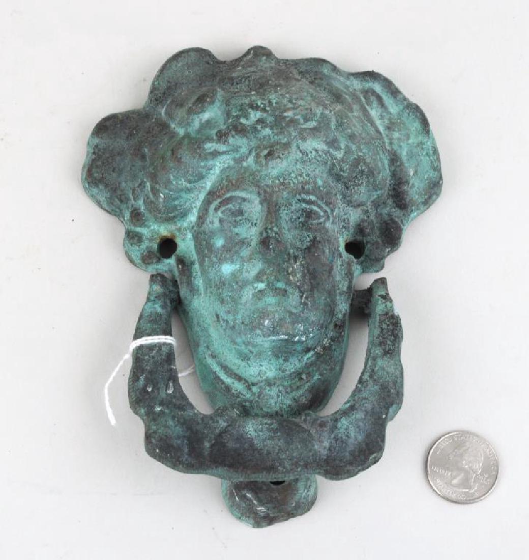 Classical Theme Figural Brass Door Knocker: Patinated classical themed figural brass door knocker. Oxidation 6 1/2" high, 5" wide. Provenance: Property of a Woodbury CT Collector.