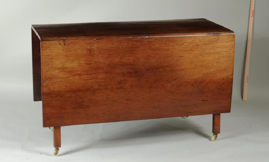 Chippendale Mahogany Drop Leaf Dining Table: Chippendale period mahogany drop leaf dining table, with worn varnish spots, loose joints, casters added and burn marks in top. 30" high, 52" long, 22" deep, 66" deep open. Provenance: Property of a S