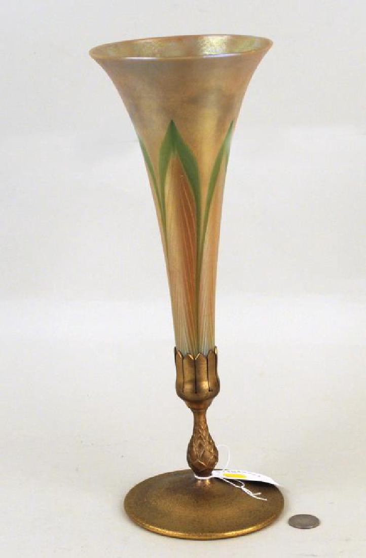 Tiffany Favrile Glass Feather Design Trumpet Vase: on dore bronze base. Glass incised "L.C.T.", base stamped "Tiffany Studios, New York, 1043". Slight patina wear to base, plant debris in bottom of vase. 14 3/4" high, 5" wide. Provenance: Property of