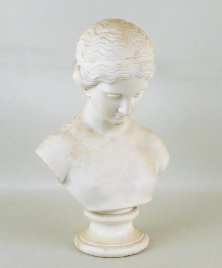 Parian Bust of Classical Woman: with two part construction and molded base. Soiling, stains, small imperfections. 16 1/2" high, 10 1/2" wide.