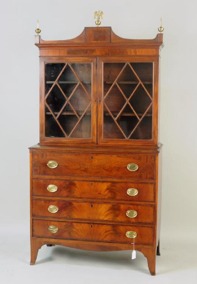 American Federal Mahogany Secretary Desk: in two parts, with arcaded upper section with diamond mullioned doors, on a base with pull out desk cabinet, with french feet. 80" high, 39 1/2" wide, 20" deep. Repairs and some losses, replaced brass