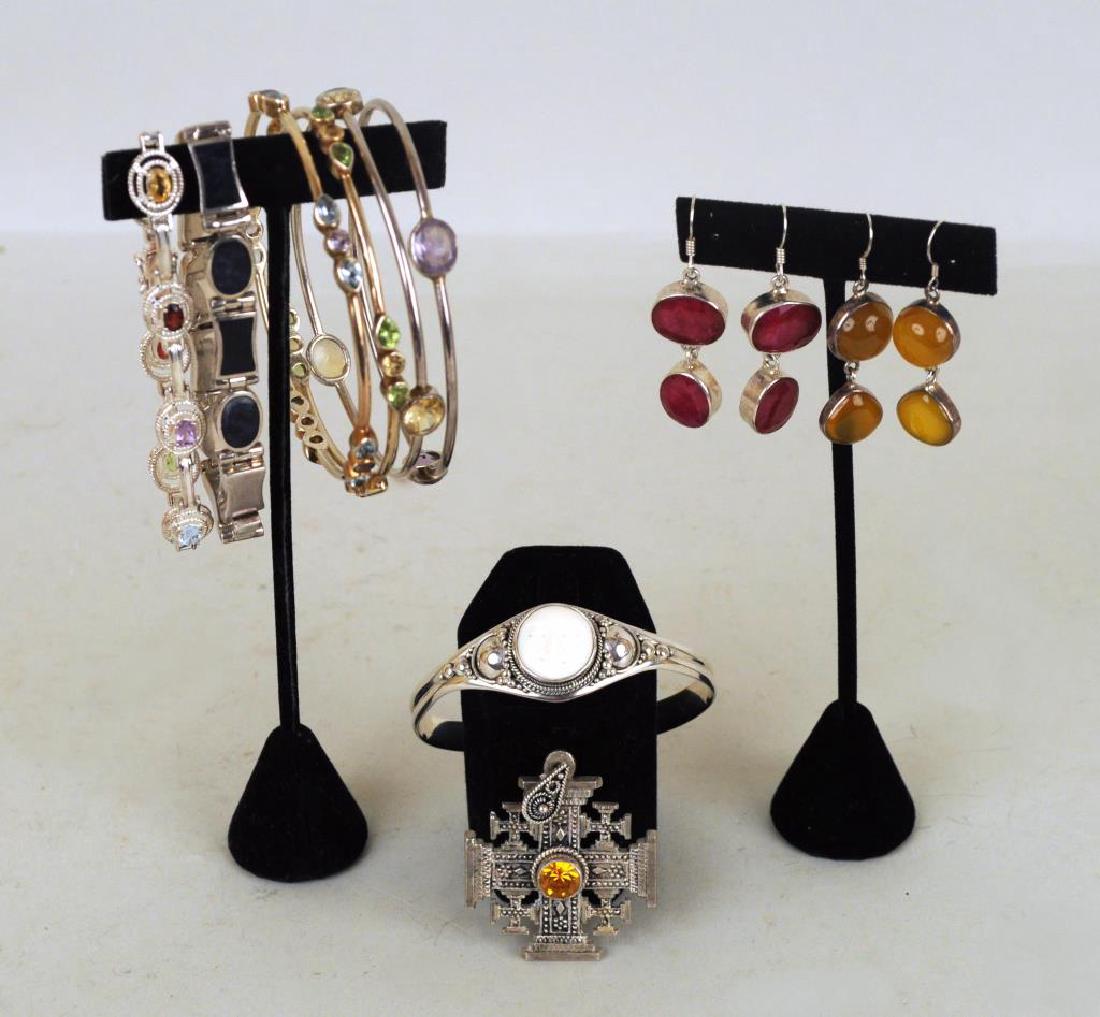 Group Ten Sterling & Stone Jewelry Items: including four bangles, two link bracelets and a Novica cuff. Use wear, light scratches. Largest: 8" long, 5/16" wide. Gross weight: 4.915 OZT.