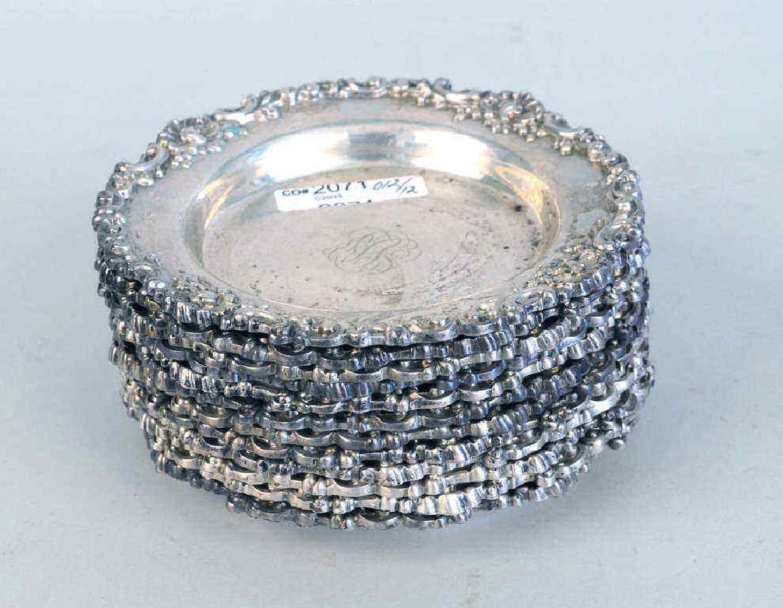 Set Twelve Sterling Wine Coasters: marked "Theodore B. Starr New York 806", monogrammed. Use wear, light scratches, small dings. 6" diameter. Weight: 54.265 OZT.