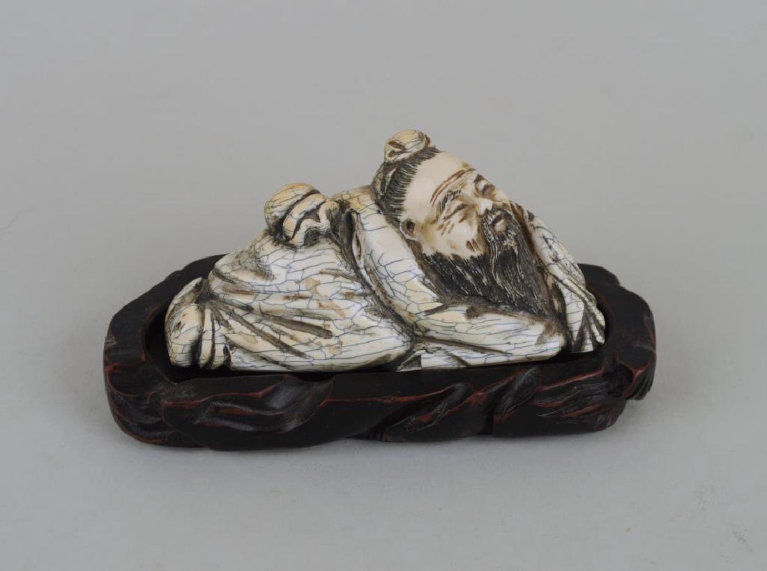 Chinese Ming Dynasty Carved Okimono/Stand: heavy signed mastodon carving of a period recumbent immortal/sage, very detailed carving. Age cracks. 2 1/4" high, 4" long. International clients may be ineligible to bid on this item which may contai