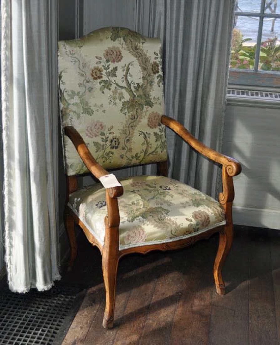 French Provincial Fruitwood Open Arm Chair: with scrolled arms and supports on cabriole legs and hoof feet. Arms previously upholstered, old wax filler present. 45" high, 25" wide, 23" deep.