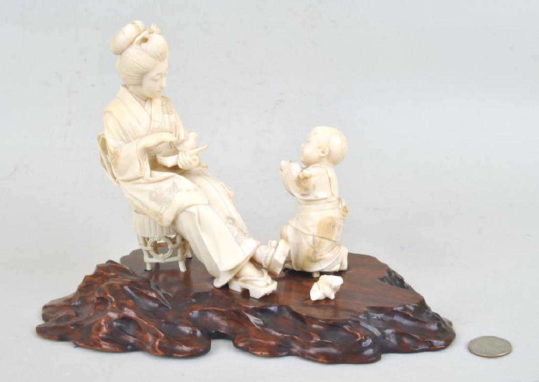 Japanese Signed Carved Group of Mother/Child: both holding chicks, signed on bottom of mother's sandal mounted on hardwood stand. Age cracks, stains; losses to mother's sandal soles, child with broken, detached but present hands. 8" high, 11" lon