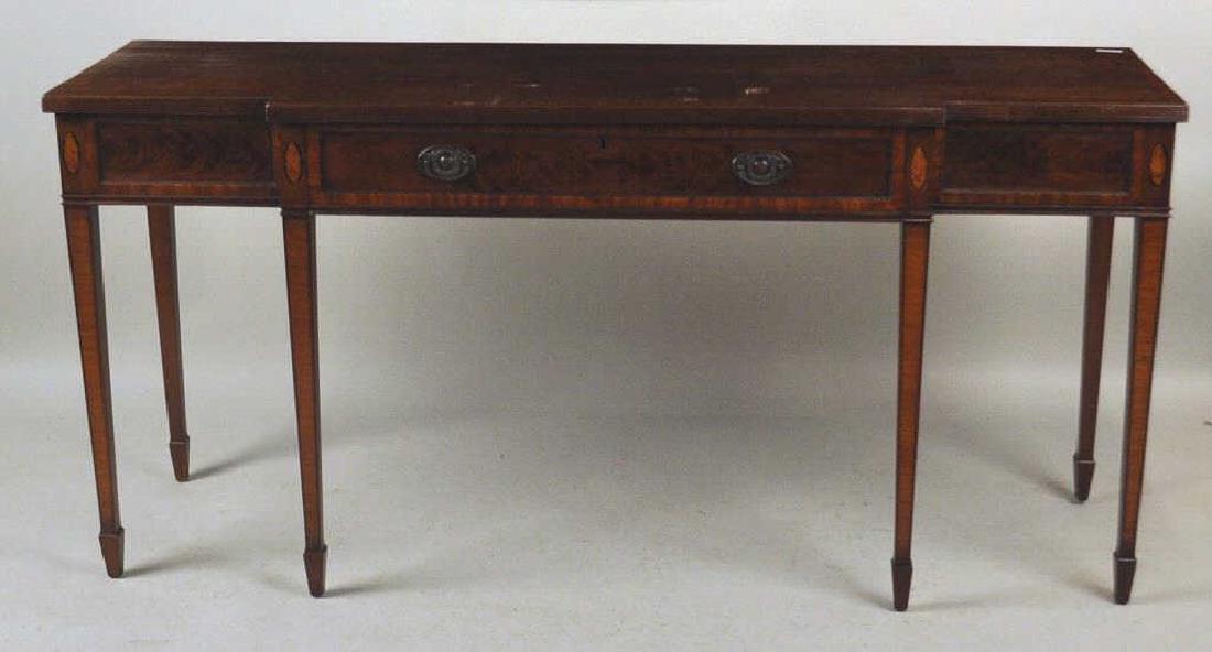 George III Style Inlaid Mahogany Sideboard: in breakfront form with reeded edge top, inlaid conch shells and tapering legs with spade feet. Expected age and use wear. 33 1/2" high, 69 1/2" wide, 20 1/2" deep. Provenance: Property from a Lexingt