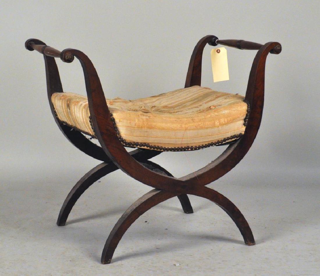 Continental Mahogany Curule Form Seat: scrolled arms with brass rosette terminals. Wear, fading, soiling, small splits to some veneers. 25" high, 28" wide, 18 1/2" deep. Provenance: Property of an early Connecticut family.