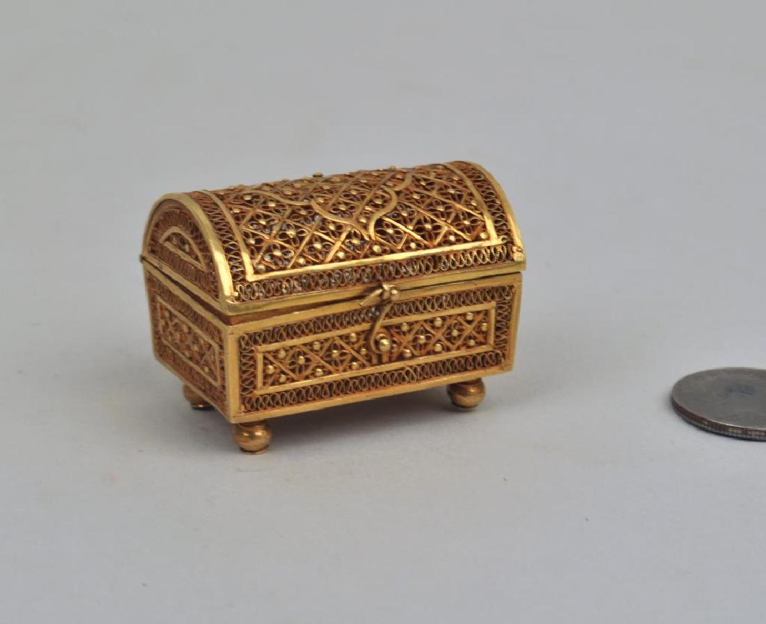 18K Gold Miniature Filigree Casket Form Box: 18K Gold Miniature Filigree Casket Form Box unmarked. Tests for 18 karat. 1 1/2" high, 1 3/4" wide. Weight: 27.10 DWT