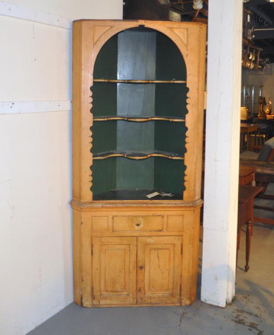 New England Painted Corner Cupboard: New England Painted Corner Cupboard with shaped upper open cabinet and three shelves over single drawer, two cupboard doors below. Paint wear, loss, lacking cornice, soiling, edge wear. 75 1/2" high, 