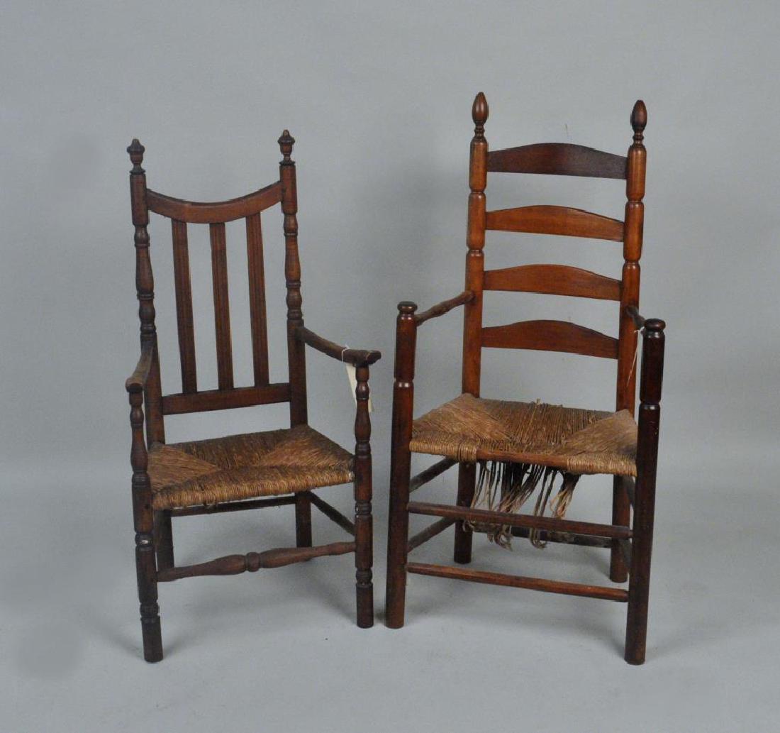 Two American Country QA Rush Seat Arm Chairs: Two American Country QA Rush Seat Arm Chairs one a slat back with tiger maple stiles, with feet ended out, and the other a ladderback with damaged seat, both in estate condition. Largest: 46" high, 22