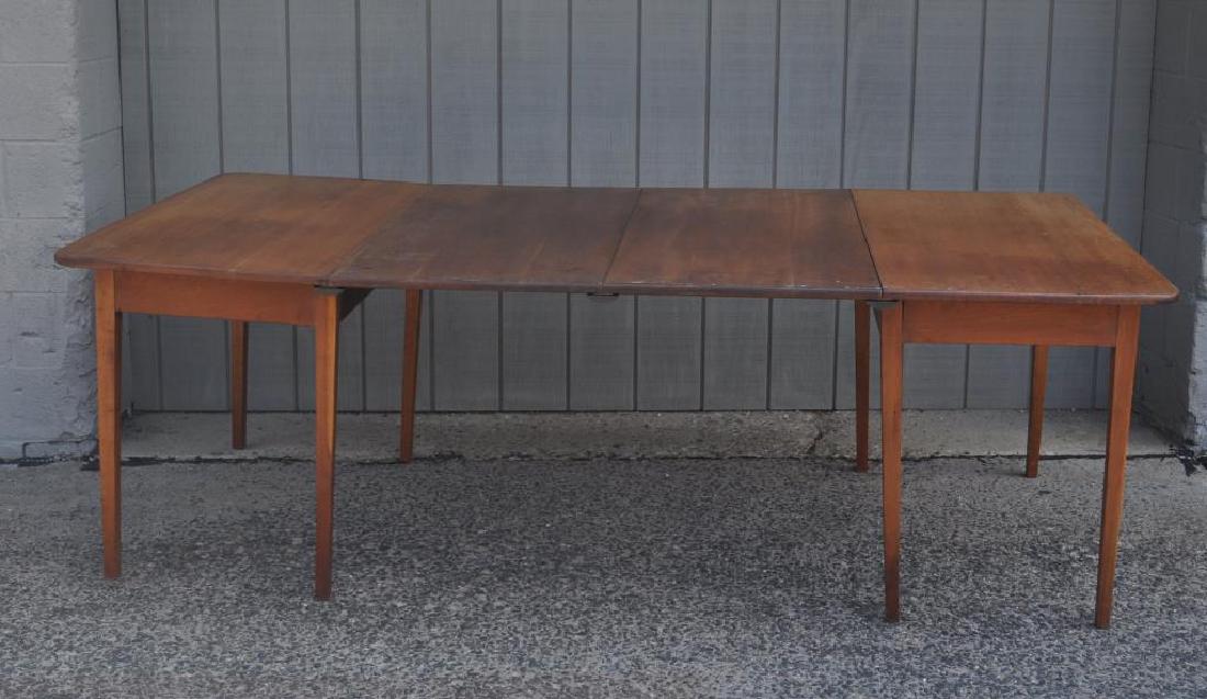 Hepplewhite Style Cherry Two Part Dining Table: Hepplewhite Style Cherry Two Part Dining Table with two original leaves, supporting rods and brass clips. Estate condition, with some wear and discoloration to top. 30" high, 23" wide, 48" deep. Open: