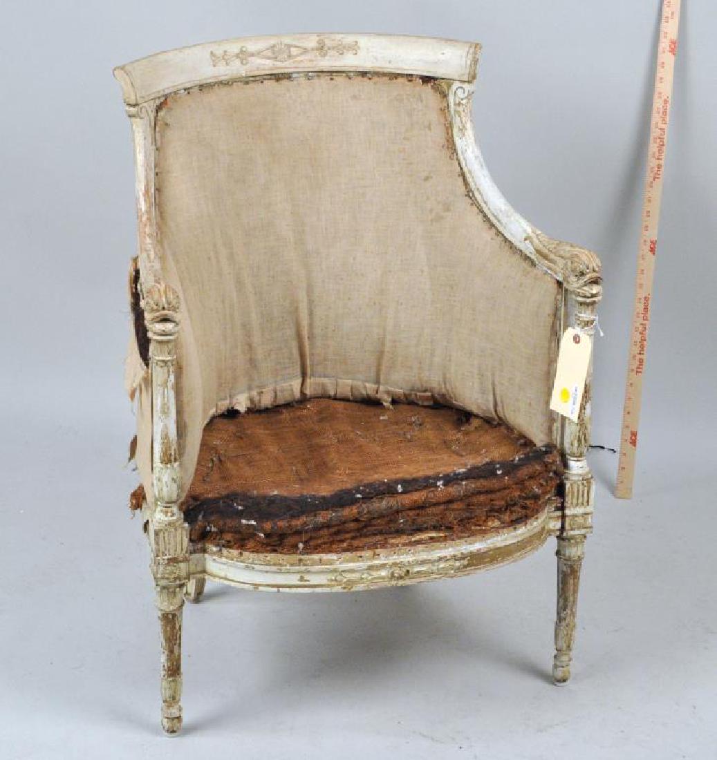 French Directoire Painted Gilt Bergere Chair: the carved frame with dolphin arm terminals. Losses to painted surfaces, estate condition, as shown. 34" high, 26" wide, 18" deep. Provenance: Property of a CT Estate.