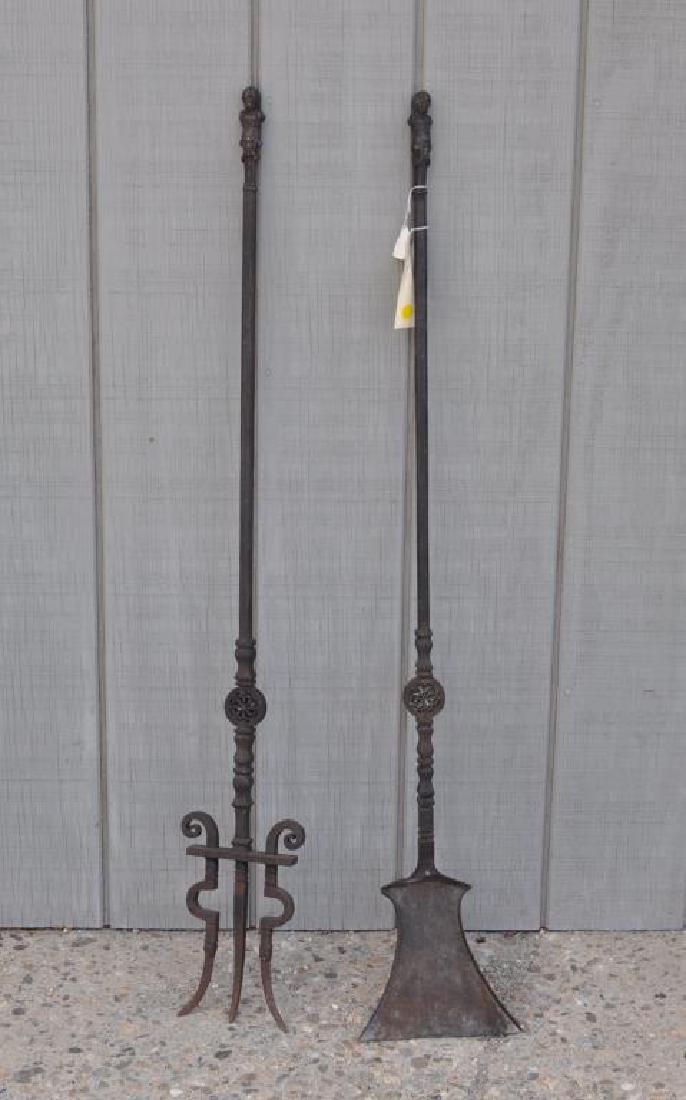 Pair Renaissance Revival Iron/Bronze Fire Tools: with figural handles. Wear and oxidation.46 1/2" long. Provenance: Property of a CT Estate.