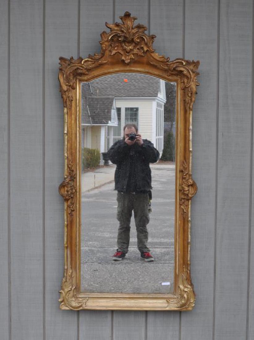 Victorian Rococo Style Giltwood Mirror: 66 1/2" high, 32" wide. Gesso cracks, restoration, silvering loss. Provenance: Property of a CT Estate.