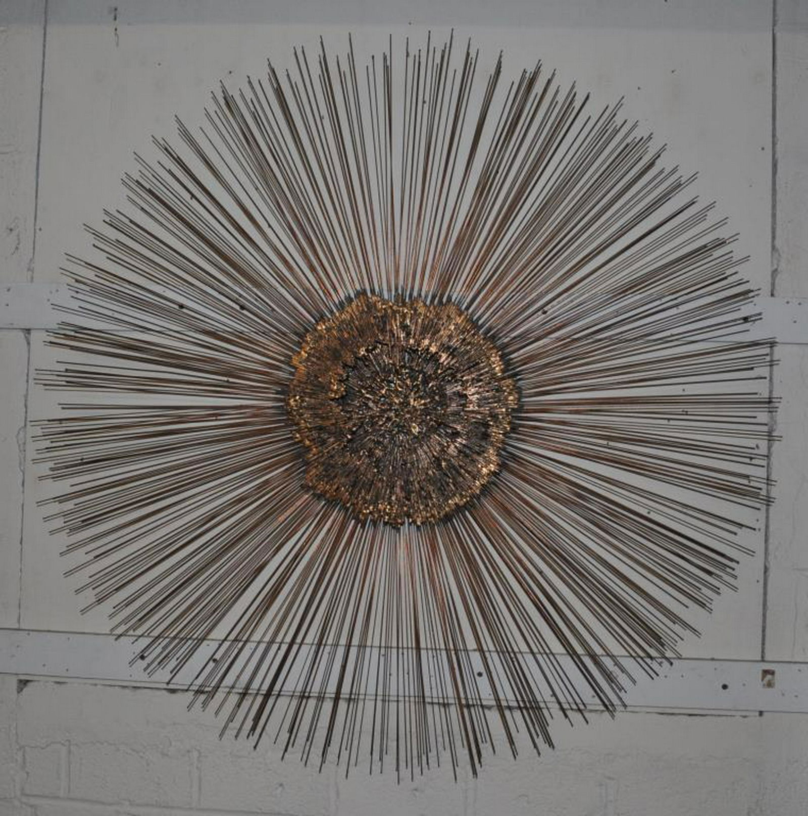 Attr. Curtis Jere. Modern Sunburst Wall Sculpture: vintage 1960s-70s brass/copper metal "sunburst" wall sculpture in the manner of Curtis Jere, measuring 43" in diameter, approximately 3" thick, some oxidation and a few slightly bent tines. Provenance