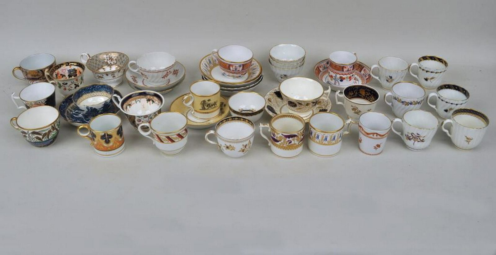 Estate Group Early Porcelain Wares: comprising a sizable group, mostly cups and saucers, various makers and patterns including several Worcester examples. Provenance: Estate of Clyde Gatlin, Southbury CT.