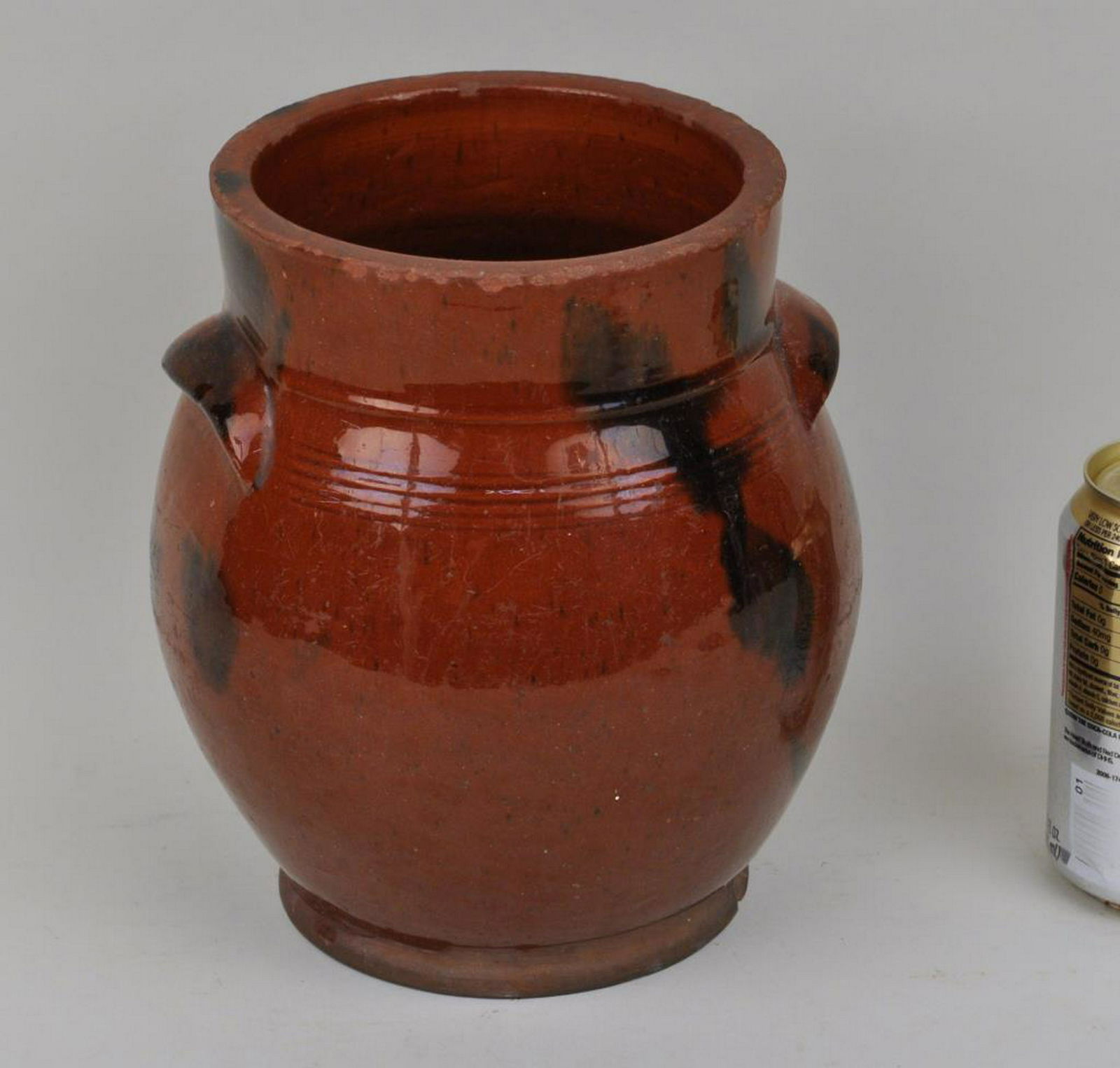 Large Redware Jar: attributed to the Day Pottery, Norwalk CT, with manganese decoration and integral handles. 8" high, 6" diameter. Provenance: Estate of Clyde Gatlin, Southbury CT.