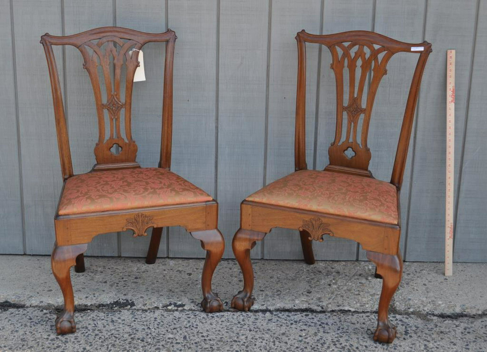 Pair PA Chippendale Carved Mahogany Side Chairs: with carved gothic splats, seat frames with leaf carving, and claw and ball feet. 38" high, 23" wide, 17" deep. Provenance: Estate of Clyde Gatlin, Southbury CT.