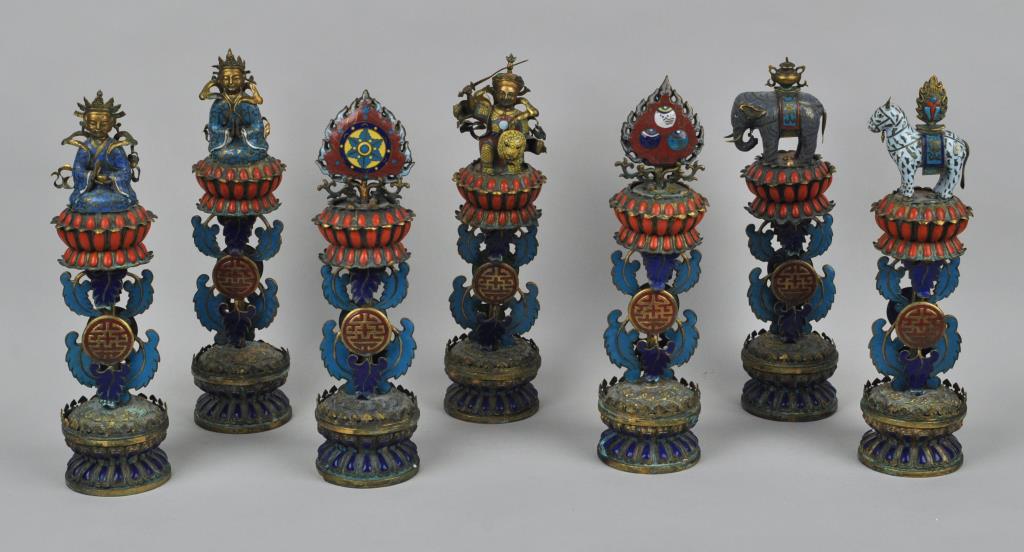 Group Seven Sino-Tibetan Buddhist Ashtamangalas: each gilt metal and enameled with coral inlay, auspicious symbols, figures and beasts on stands with double lotus base. 13" high. Light wear to some elements.