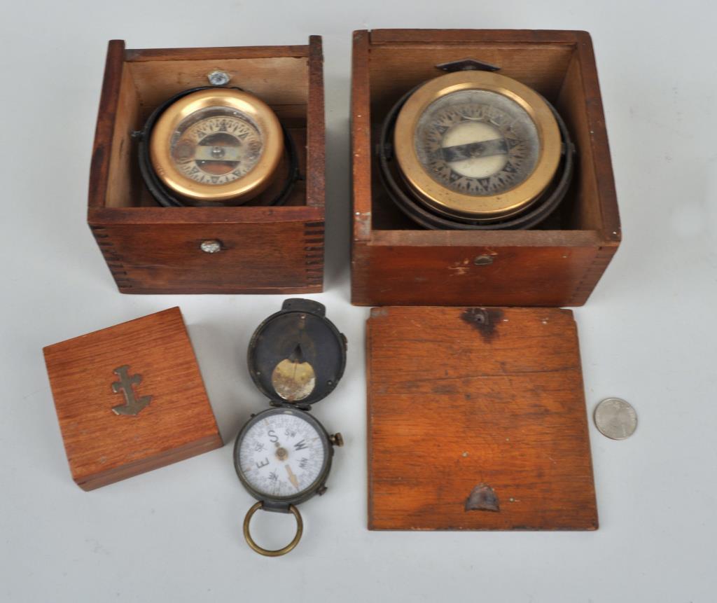 Group Four Vintage Compasses/Cases: comprising three ship gimbal compasses and one U.S. Engineers Corps compass. Largest: 5 1/2" high, 5 1/2" wide. Use wear, cloudy glass, one missing wood lid; wood with age cracks, stains. Provenance: