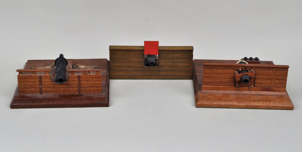 Three Model Naval Cannons: each on deck form stand, 20th century. Largest: 3 1/4" high, 8 1/2" wide, 8 3/4" deep. Provenance: Property of a New Haven County CT Estate.