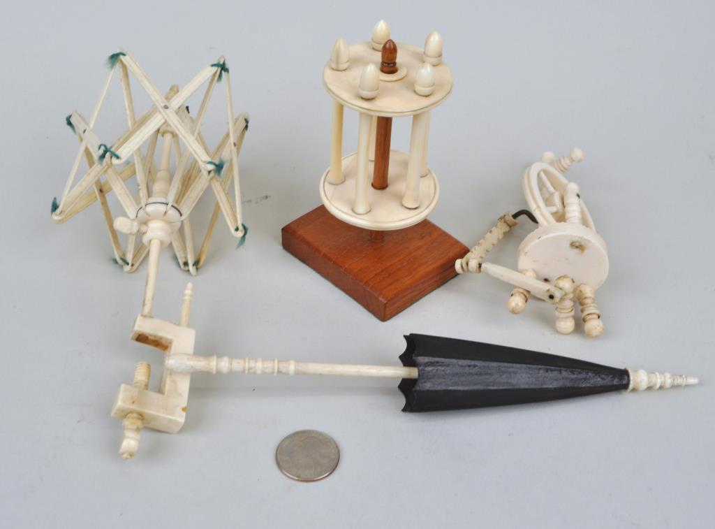Group Four Turned Whalebone/Bone Sewing Items: comprising a swift, spinning wheel, yarn winder and needle case. Largest: 7 3/4" long, 1 1/4" wide. Loss to spinning wheel. Provenance: Property of a New Haven County CT Estate.