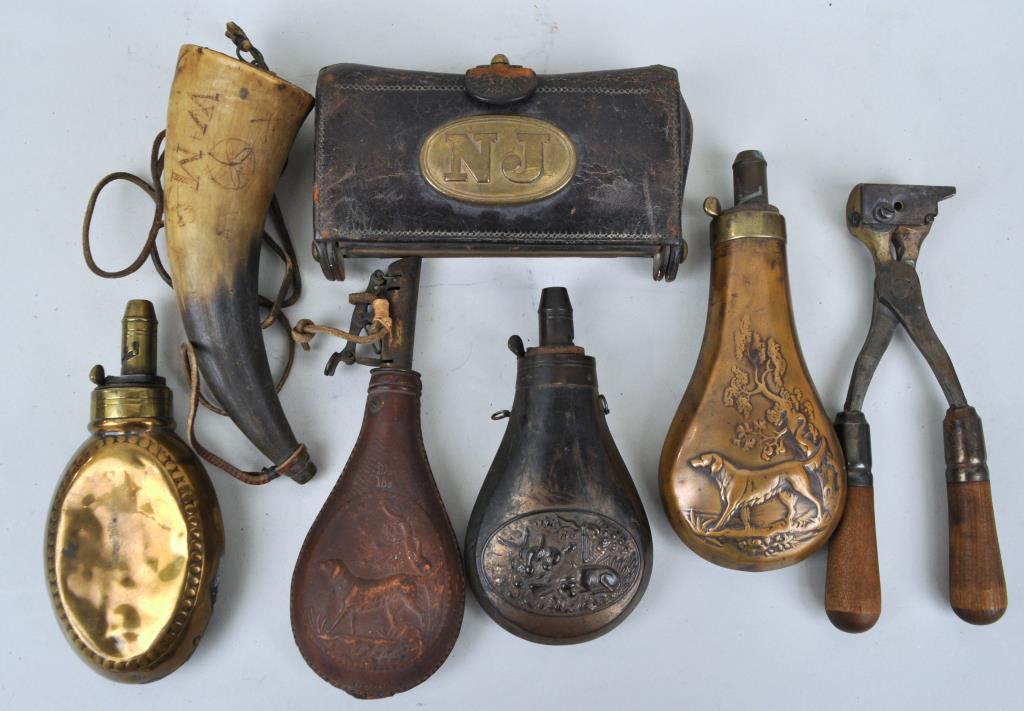 Group Powder Flasks, Powder Horn: Powder hunting flasks in brass and leather, together with a whale engraved powder horn, bullet mold, and 19th century cartridge case. Largest: 8" long. Wear and oxidation consistent with age and use. 