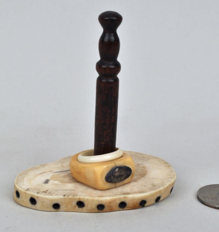 Sailor's Walrus Bone Ringstand with Two Rings: one ring with applied silver clamshell. 3 1/2" high, 3" wide. Age cracks, soiling. Provenance: Property of a New Haven County CT Estate.