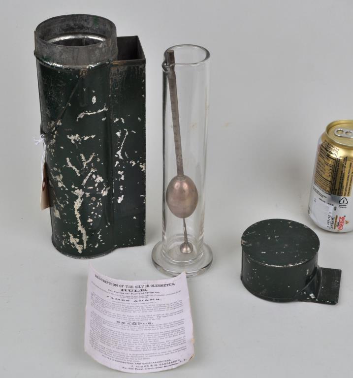 Cased Adams & Tagliabue Oleometer: "For testing the purity of sperm oil" with silver tester and glass beaker in metal case. 11 1/4" high, 3 1/4" wide, 4" deep. Provenance: Property of a New Haven County CT Estate.