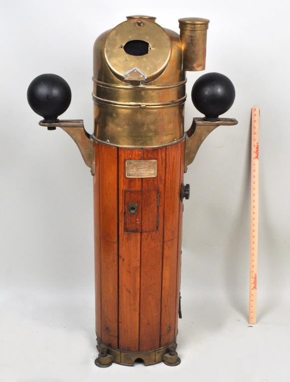 Sestrel Ship's Binnacle: Henry Browne and Son, Essex. Hardwood case with brass domed lid and iron compensation spheres. 51" high, 28" wide, 17" deep. Wear consistent with age and use, damage to interior of dome. Provenance: P