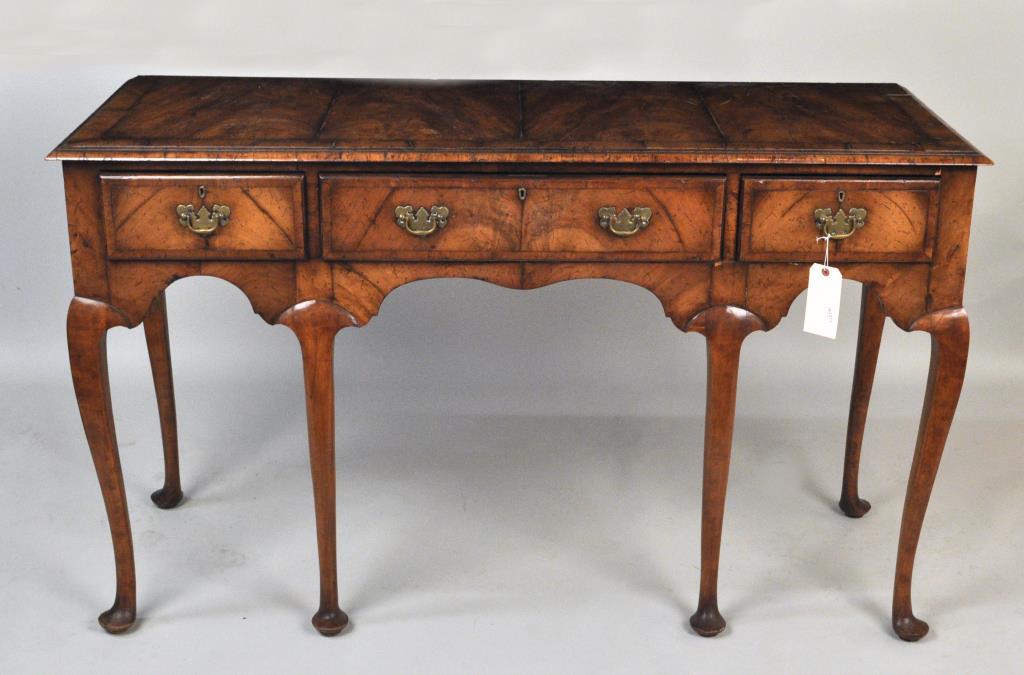 English Queen Anne Style Walnut Serving Table: 36" high, 60" wide, 22 1/2" deep. Finish wear, loss, a few small veneer losses, in distressed finish to give the appearance of age, slight veneer lifting to top.