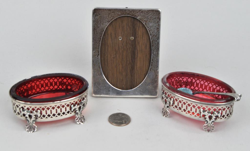 Pr. Sterling Gorham Salts, Spoon, Cartier Frame: the salts with rose glass liners. Largest: 4" high, 3" wide. Oxidation to spoon, a few small bends to undersides of salt frames, small corner dent to frame. Weight: 2.825 OZT. *No credit card payments