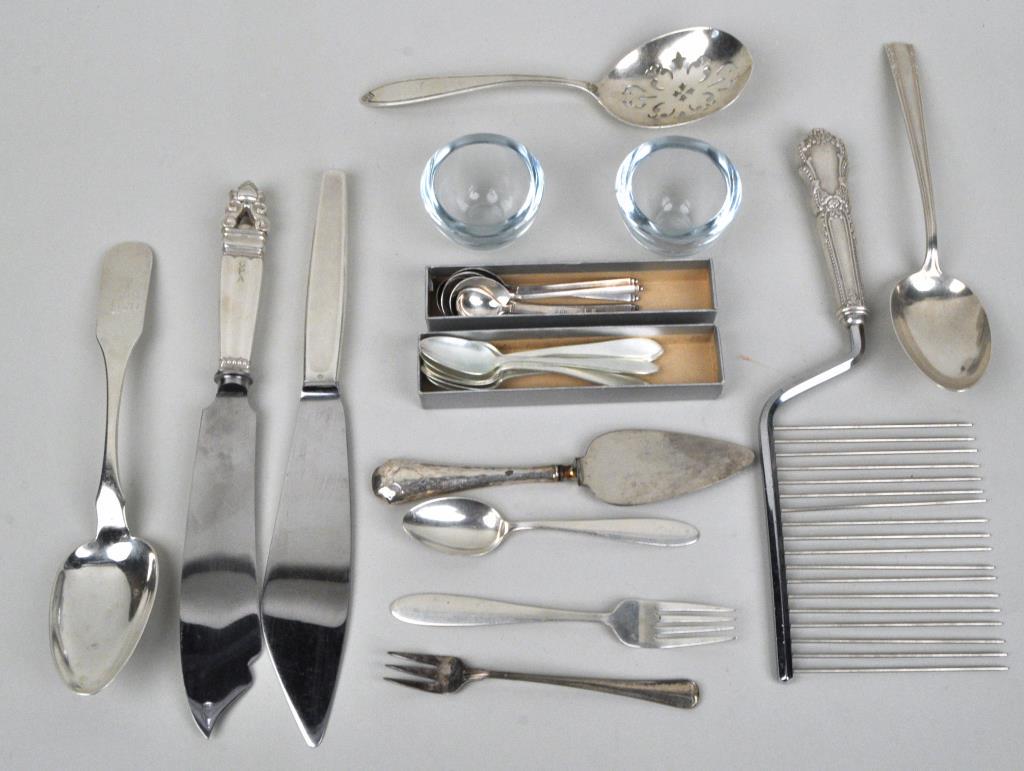 Group Sterling Utensils, Including Jensen, Tiffany: comprising 2 Georg Jensen serving knives, 1 in "Acorn" pattern; 6 Tiffany & Co. demitasse, 6 English demitasse and other sterling, together with a replica coin silver spoon. Largest: 10 3/4" long, 3 7