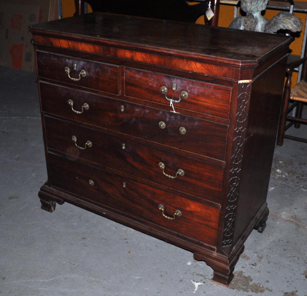 George III Carved Mahogany Chest: with blind fret carved canted corners, ogee feet. 39 1/4" high, 43 1/4" wide, 20 1/2" deep. Losses to moldings, missing some hardware; finish wear, loss; old stains, scratches, marring to top.