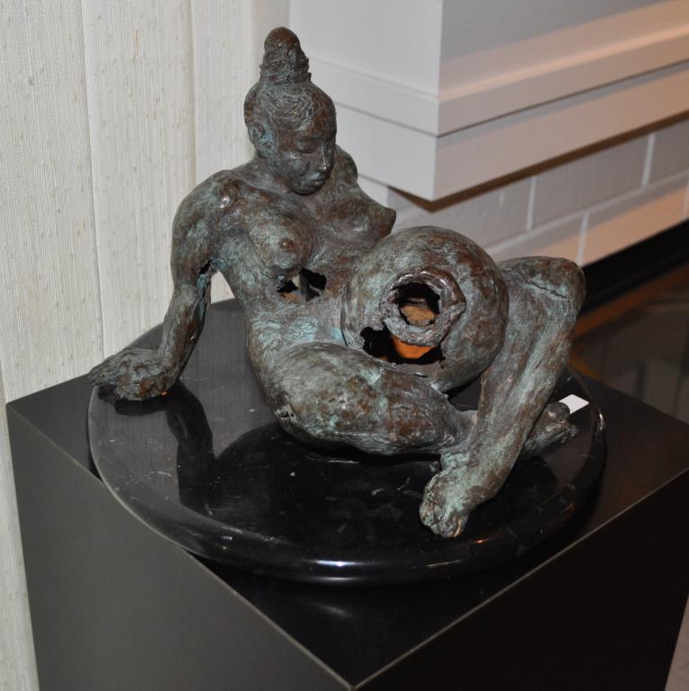 Cast Bronze Meso-American Reclining Figure: with jar on a marble stand, signed, dated indistinctly. 8 1/2" high, 12" diameter. Casting imperfections.