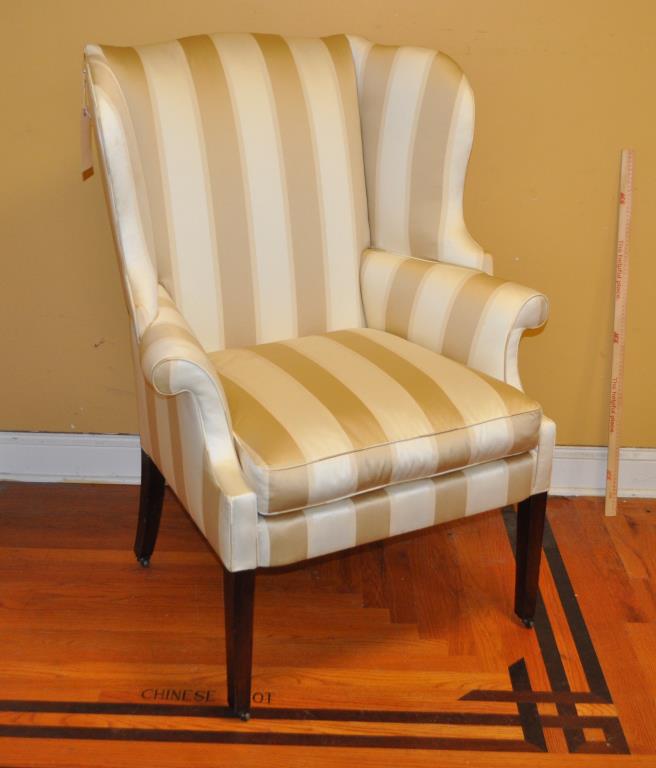 Philadelphia Hepplewhite Wing Chair: on tapered legs with casters. 46 1/4" high, 33 1/4" wide, 21" deep. Old edge nicks, small losses to legs, a couple light stains to upholstery. Property of a Fairfield County collector.