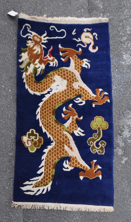 Chinese Dark Blue Ground Dragon Rug: 6' by 3'. Damage to center. All rugs sold "as is." Provenance: Estate of Lucy Jarvis, NYC.