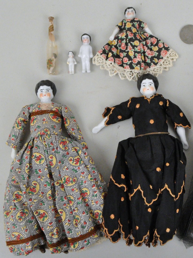 Group of Six Antique Porcelain Dolls: three Jenny Lind and three miniatures. The three largest in original clothing. Largest: 8" high, 4" wide. Glaze wear, loss to shoes of two largest. Provenance: Property of a Litchfield County History 