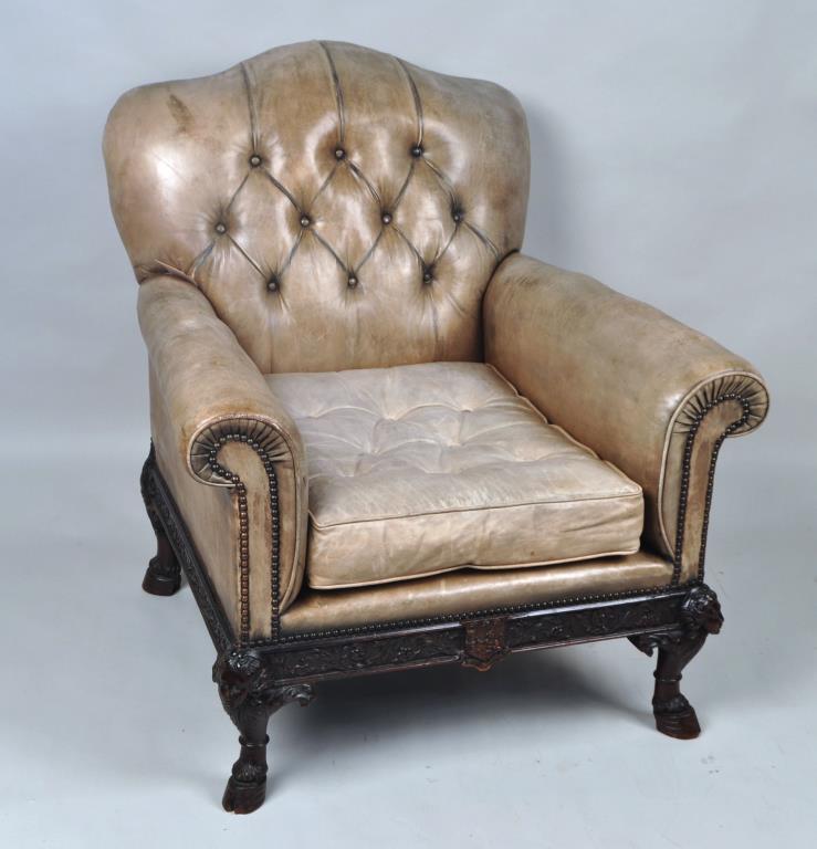 Fine English Carved Mahogany Leather Library Chair: with nicely patinated green leather upholstery, elaborately carved satyr form hoofed leg base with emblematic and geometric relief carvings,19th century. 41" high, 37" wide, 33" deep. Expected age and
