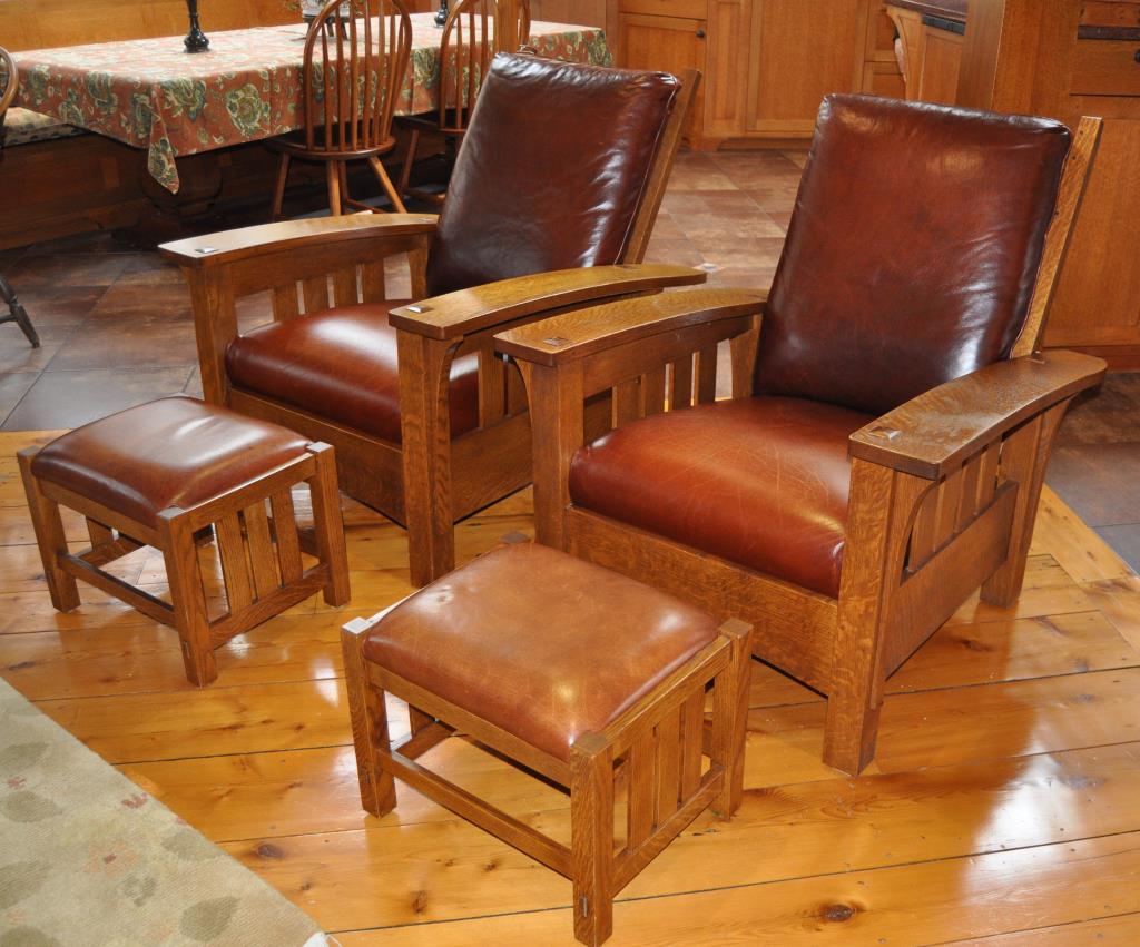 Pair Stickley Mission Oak Armchairs & Ottomans: the armchairs with slatted backs and adjustable mechanism, with leather upholstered cushions, 20th century, labeled on base "Stickley, Manlius NY." **This item is being offered from the premises and i