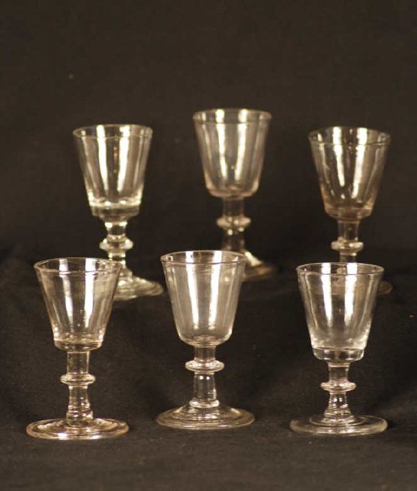 Six Blown 19th Century Wine Glasses: An assembled set of six blown 19th C. wine glasses which have snapped pontils and a folded foot. 4" high, 2 1/2" wide. (6 pc)