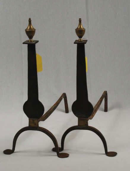 Pair of Knifeblade Andirons: Pair of brass and iron urn top knifeblade andirons. American. late 18th century. Oxidized throughout, loss to top of one finial. 20" high, 9 3/4" wide, 19" deep. (2 pc)