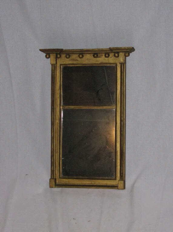 Rare Small Sheraton Mirror: Very rare diminutive federal carved and gilded Sheraton style architectural mirror, with cove molded cornice above gilded balls and two mirror plates, flanked by lobed columns. American, early 19th ce
