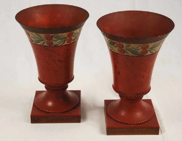 Pair of Painted Tole Urns: Pair of 20th century red painted red Tole urns, with strawberry decoration. Some pitting and rust inside. 10 3/4' high, 5" wide. (2 pc)