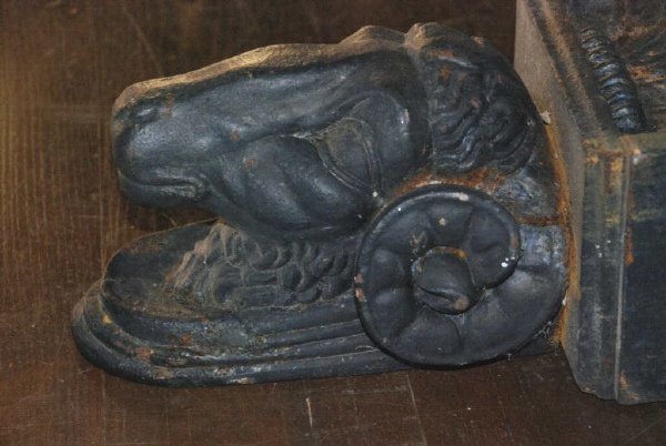 Pair of Cast Iron Rams Head Corbels: Pair of cast iron ram's head corbels, in two sections. Salvaged from the face of a 19th C. building, fine casting details. Good condition, some surface loss. 19" high, 12" high, 8" wide. (2 pc)