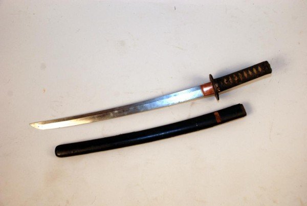 Japanese Shoto Sword: Japanese Shoto sword, 20th century. Likely reduced in length, losses to scabbard. 24 3/4" long overall. Provenance: Fairfield County CT Collection.
