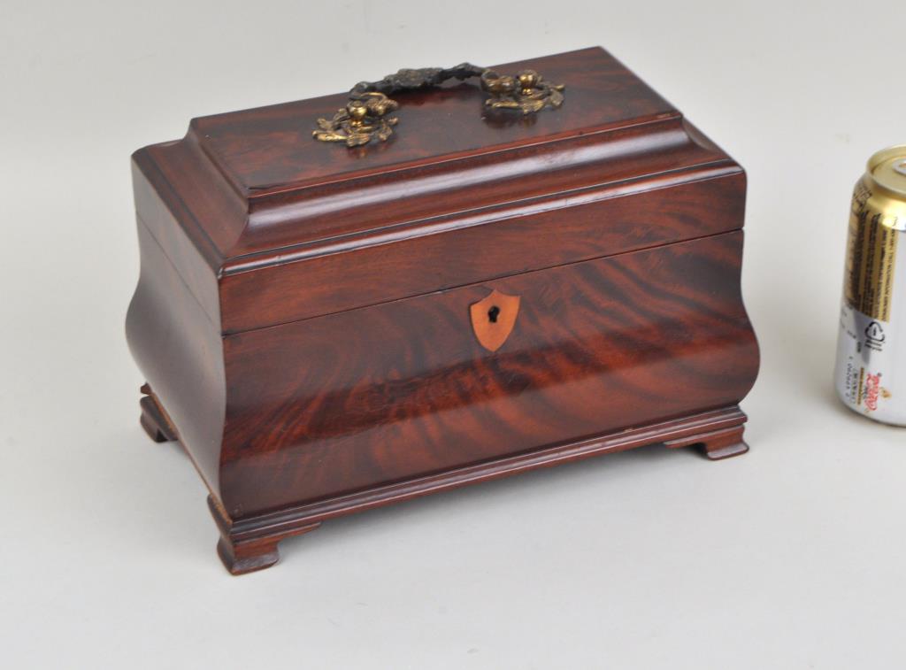 George III Bombe Form Mahogany Tea Caddy: with original interior lids, both bone knobs broken, one knop present; one hinge with loose screws. Moulding loss to lower left side. 6 3/4" high, 10" wide. Provenance: Property of a Greenwich CT Coll