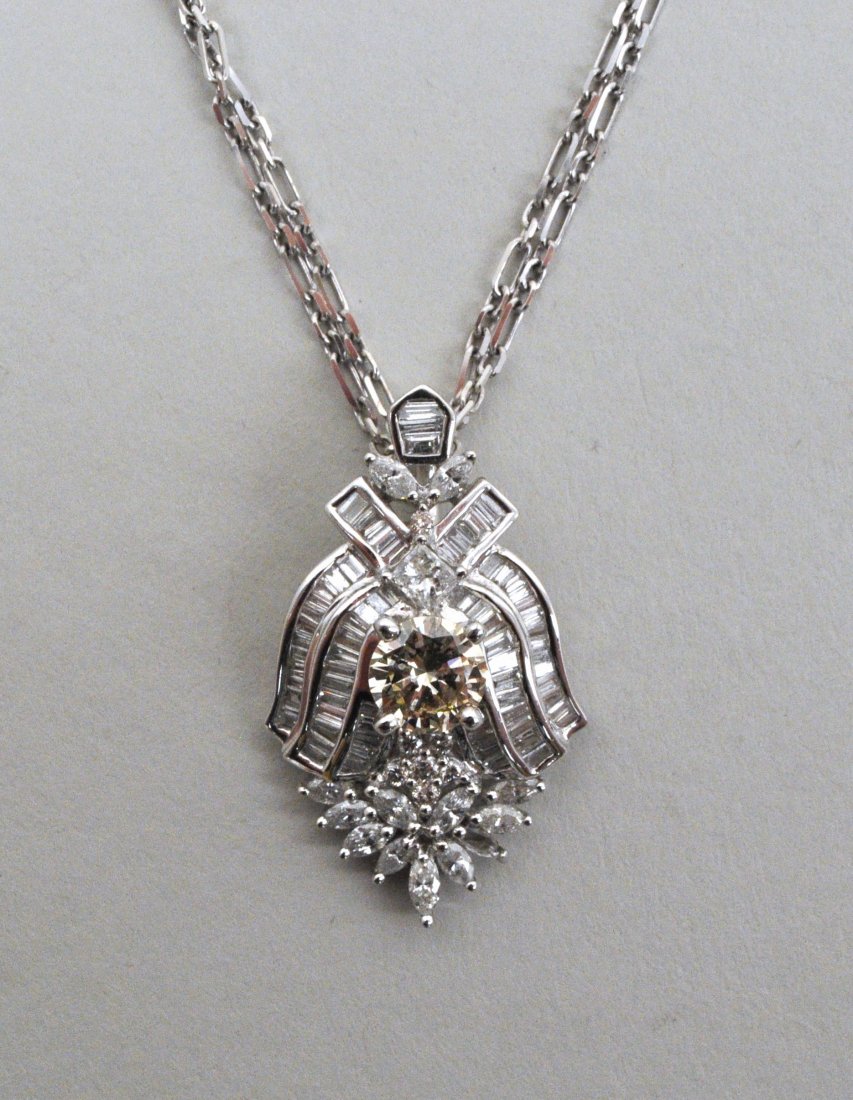 18K White Gold & Diamond Pendant/14K Gold Chain: the pendant set with center yellow diamond approximately .99 carats, SI1-VS2 clarity, surrounded by baguette, pear shaped and round diamonds approximately 1.50 carat total weight. Pendant (enhancer) 4