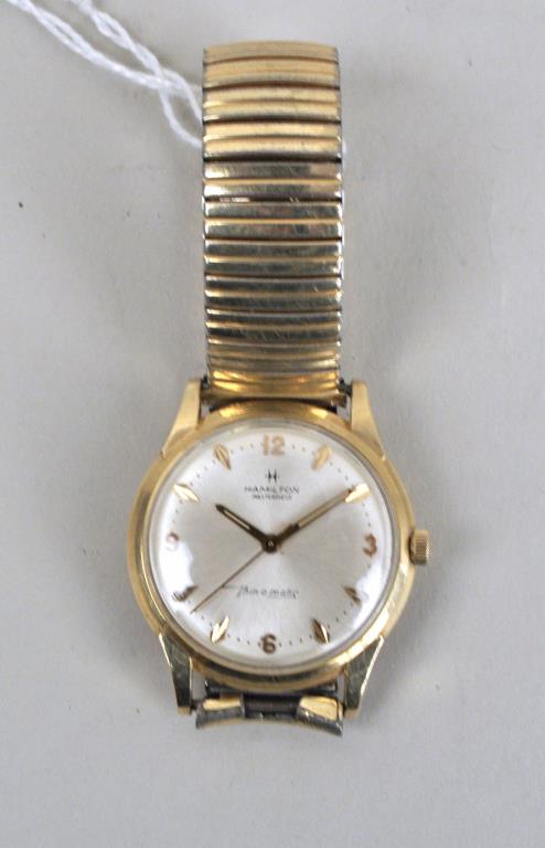 Hamilton Masterpiece 14K Gold Men: second hand moving, but not tested for accuracy, etc. Inscribed "Beneficial 25 Year Club For Accuracy", FB Oelschlager, 1931 -1956. 1 1/2" wide, 6" long. Band not gold. Provenance: Property of a Rockl